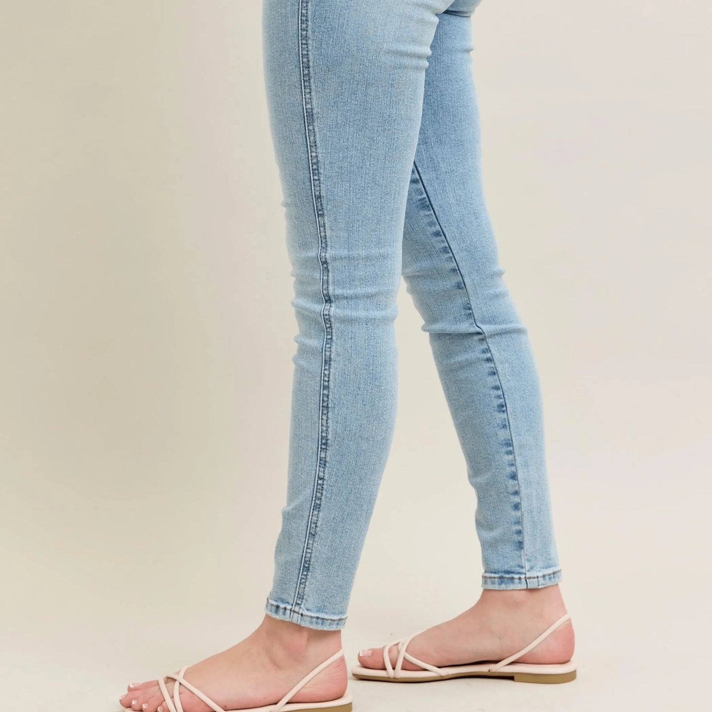 Model wearing light blue vintage wash skinny jeans for a fashion-forward look.