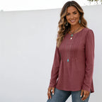 Women's brick red long sleeve crew neck essential top with elegant pleated detailing and a relaxed fit.