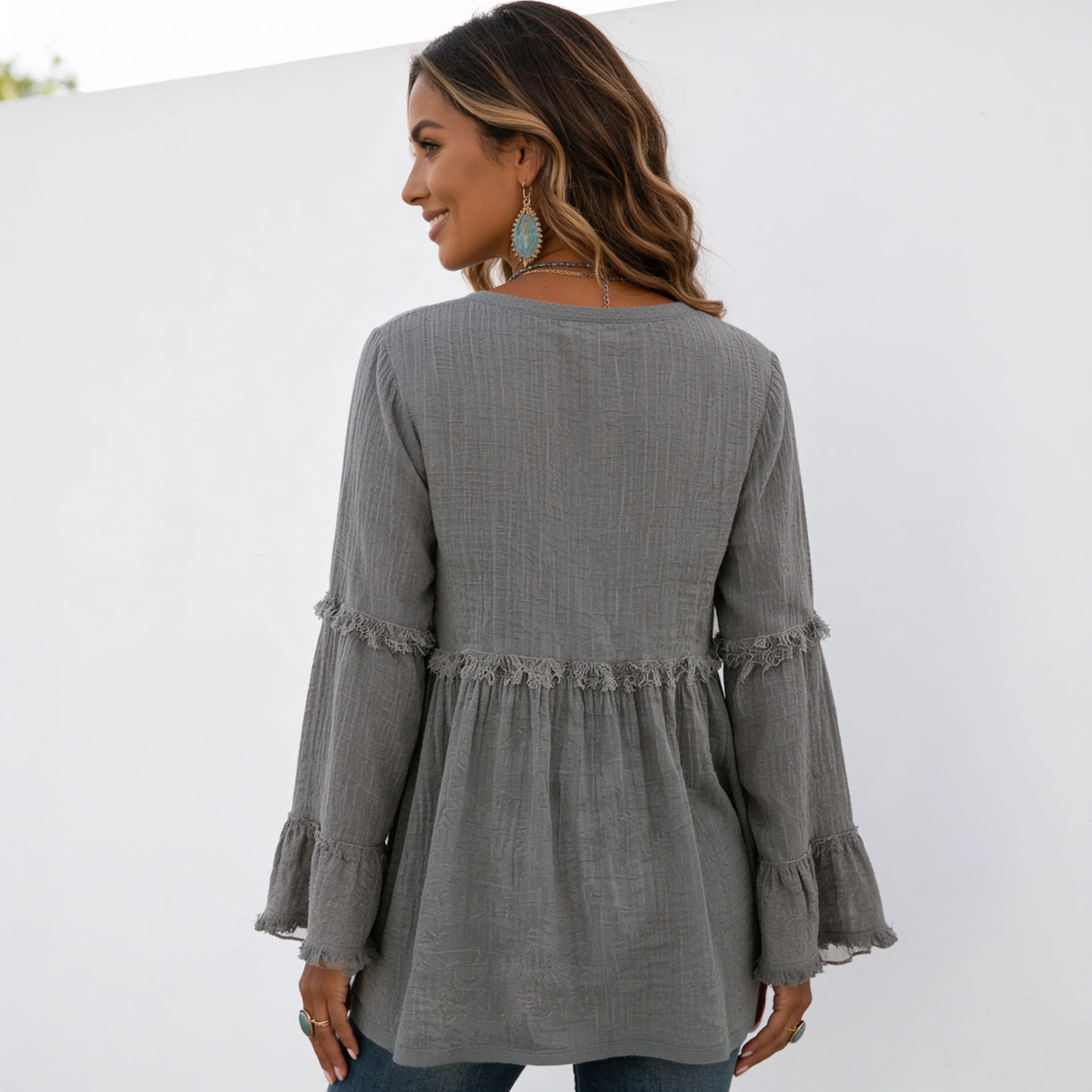 Back view of women's gray long sleeve lace trim top with lace trim yoke, flowy fit, and long bell sleeves.