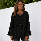 Women's black long sleeve lace trim top featuring a pleated front, lace trim accents, decorative buttons, and bell sleeves.