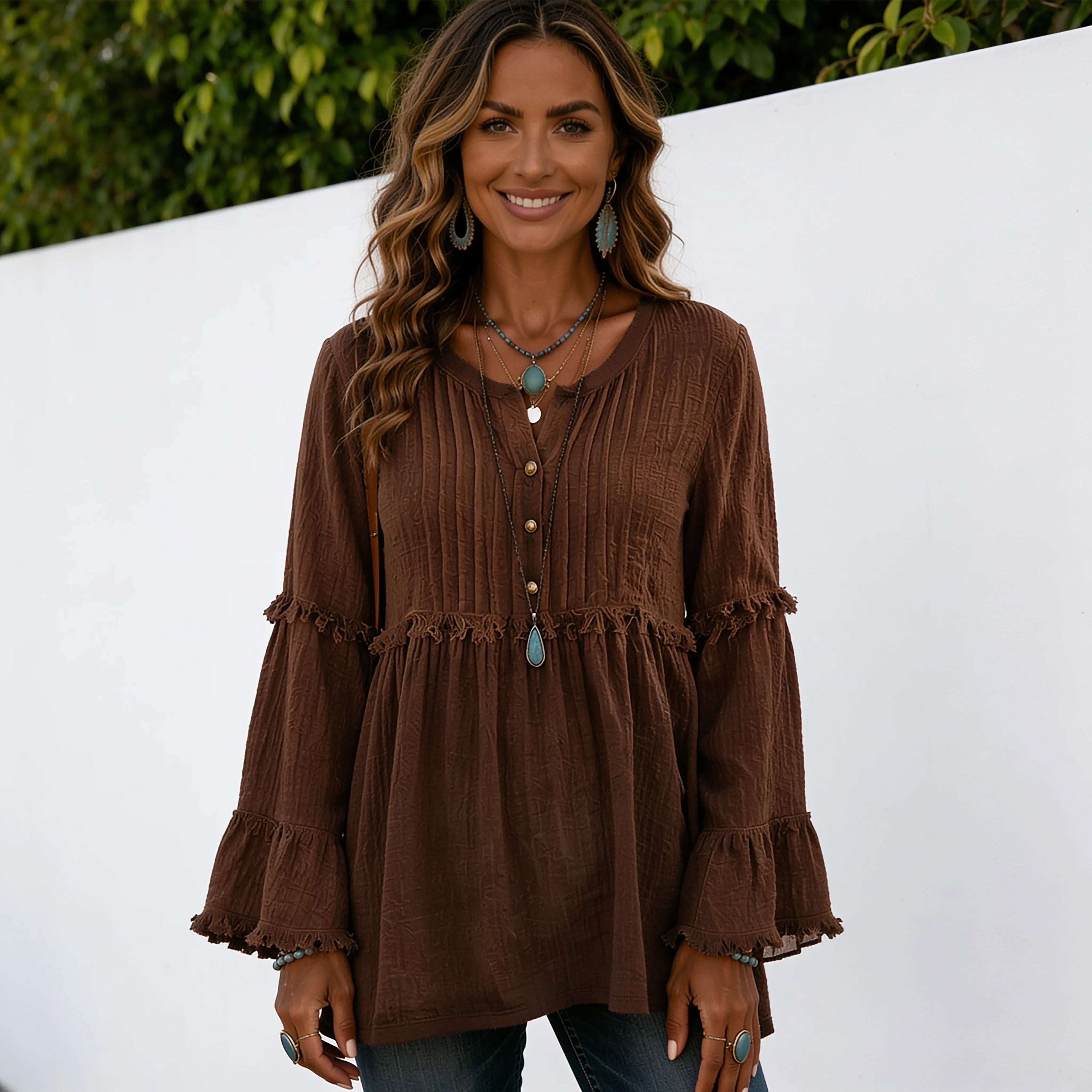 Women's coffee brown long sleeve lace trim top featuring a pleated front, lace trim accents, decorative buttons, and a loose, flowy silhouette.