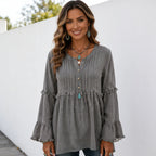 Women's gray long sleeve lace trim top with pleated front, ruffle bell sleeves, and relaxed fit shown from the front.