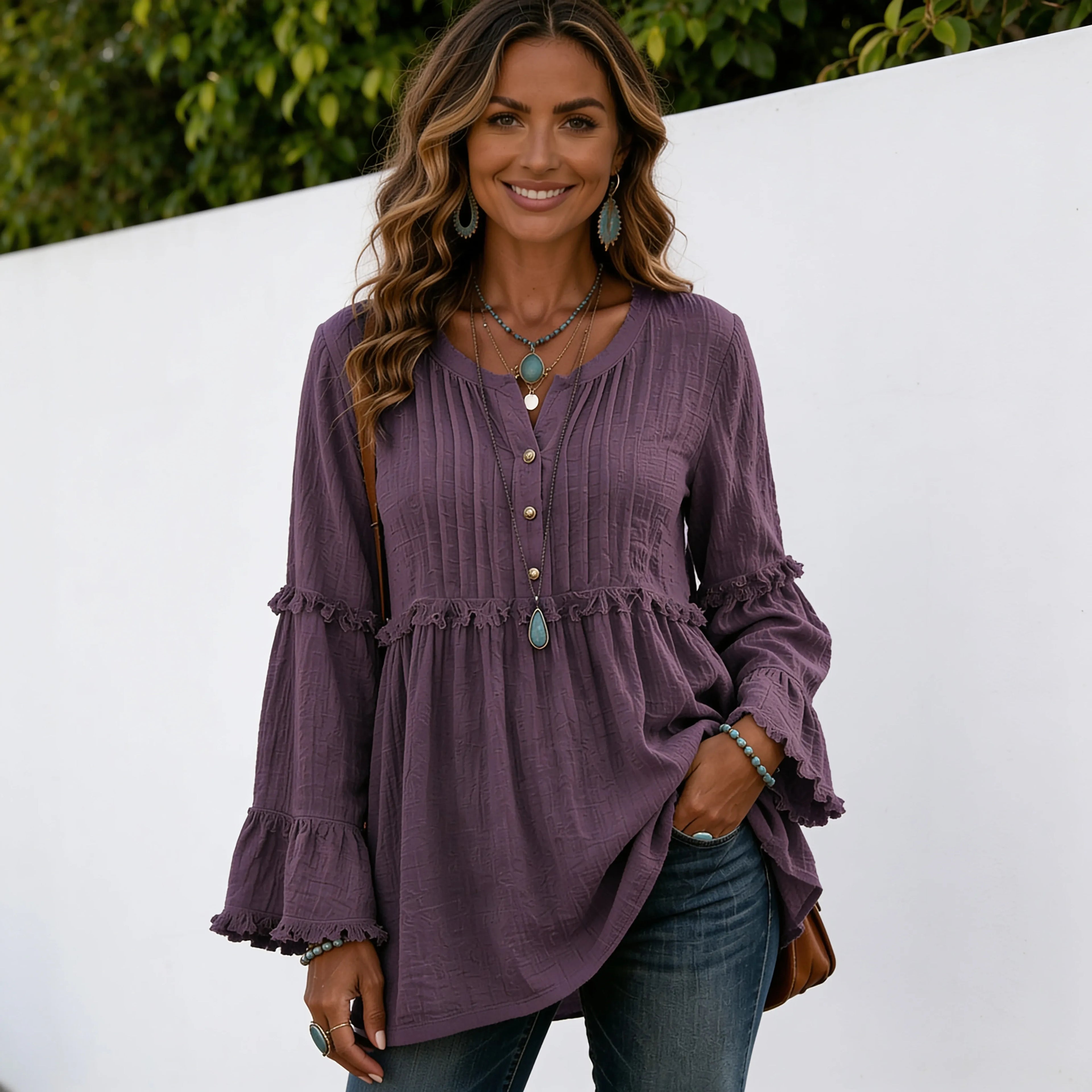Women's purple long sleeve lace trim top with textured fabric, lace trim details, pleated front, and flowy silhouette.