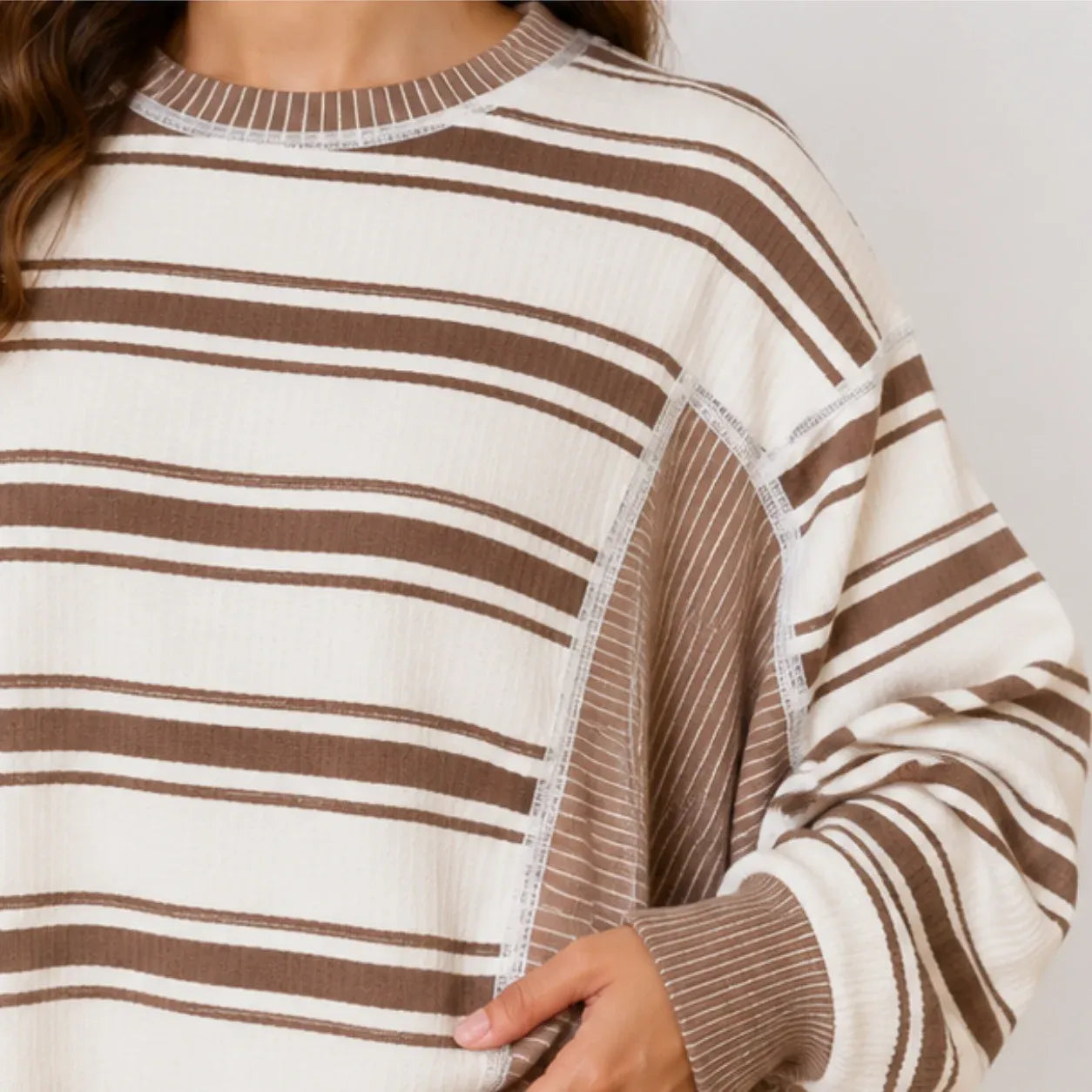 Close-up of striped knit fabric and ribbed detail on women's pants set