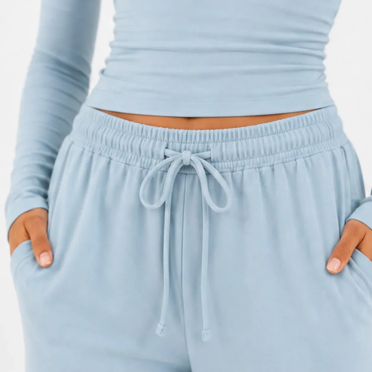 Close-up of light blue long-sleeve top and wide-leg pants two-piece set showing drawstring waist and pockets