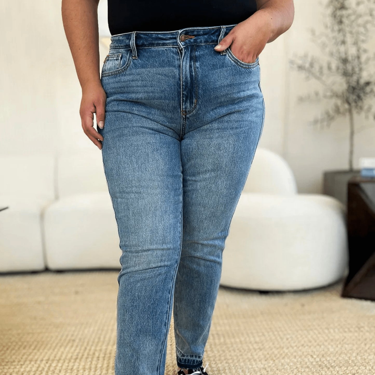 Front view of Judy Blue release hem jeans showing the raw edge detail.