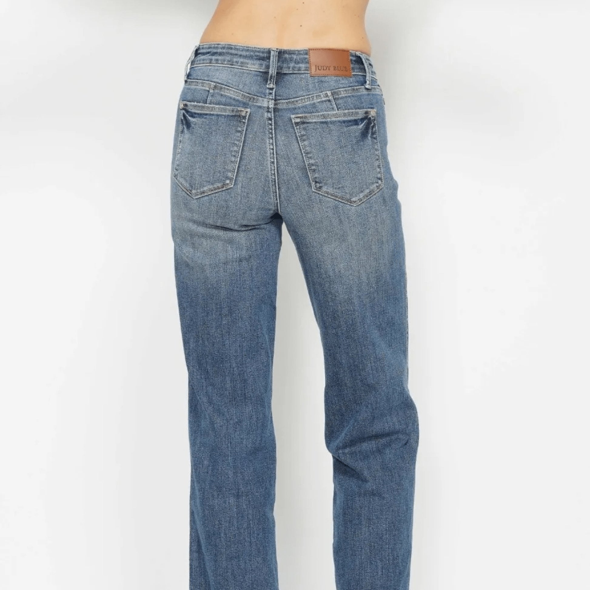 Back view of high-waist straight-leg jeans showing the classic pocket design.