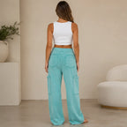 Back view of women's turquoise mineral wash wide leg cargo pants with a comfortable relaxed fit and utility pocket details.