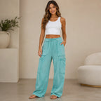 Women's mineral wash wide leg cargo pants in turquoise shown from the front with a relaxed fit and utility cargo pockets.