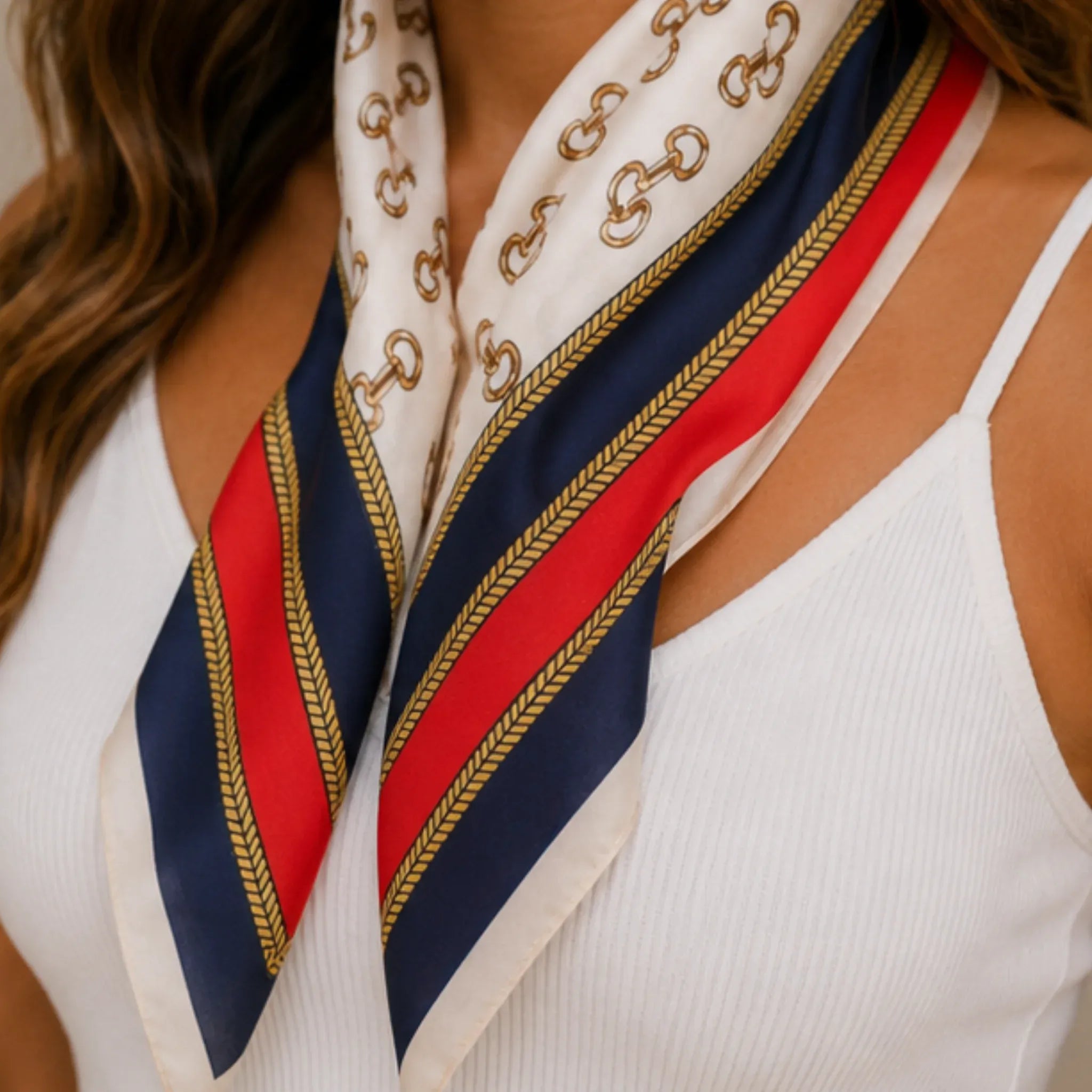 Close-up of a navy multi print bandana scarf featuring a nautical-inspired chain pattern and bold stripe accents.