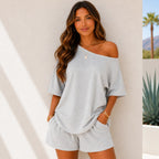 Woman wearing the Off-Shoulder Lounge Top & Shorts 2-Piece Set in light gray with an oversized top and matching shorts.