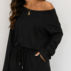 Close-up of black off-shoulder top and drawstring wide-leg pants set