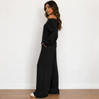 Side view of black off-shoulder long-sleeve wide-leg pants set