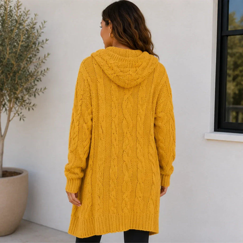 Back view of yellow oversized cable knit cardigan with hood and cable knit texture