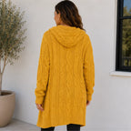 Back view of yellow oversized cable knit cardigan with hood and cable knit texture