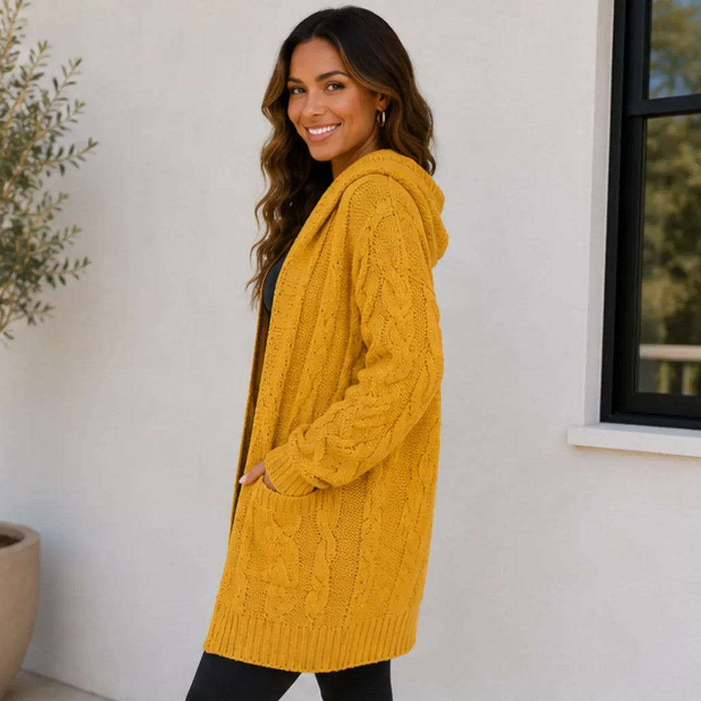 Side view of woman wearing a yellow oversized cable knit open-front cardigan