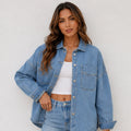 Women's oversized blue denim shirt jacket front view featuring a relaxed fit, button-front closure, and chest pockets.