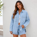 Woman wearing a light wash oversized denim shirt jacket styled with denim shorts and a white tank for a casual everyday look.