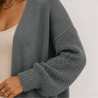 Close-up of the gray oversized open front long cardigan highlighting the chenille knit texture, balloon sleeve, and ribbed cuff detail.