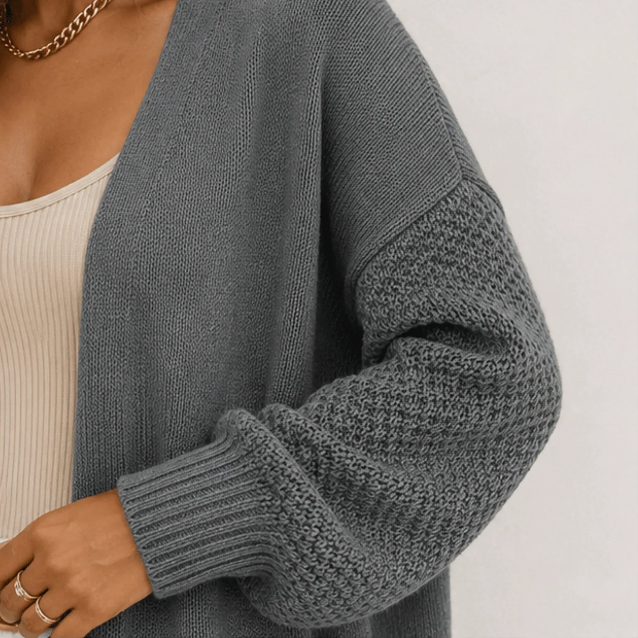 Close-up of the gray oversized open front long cardigan highlighting the chenille knit texture, balloon sleeve, and ribbed cuff detail.