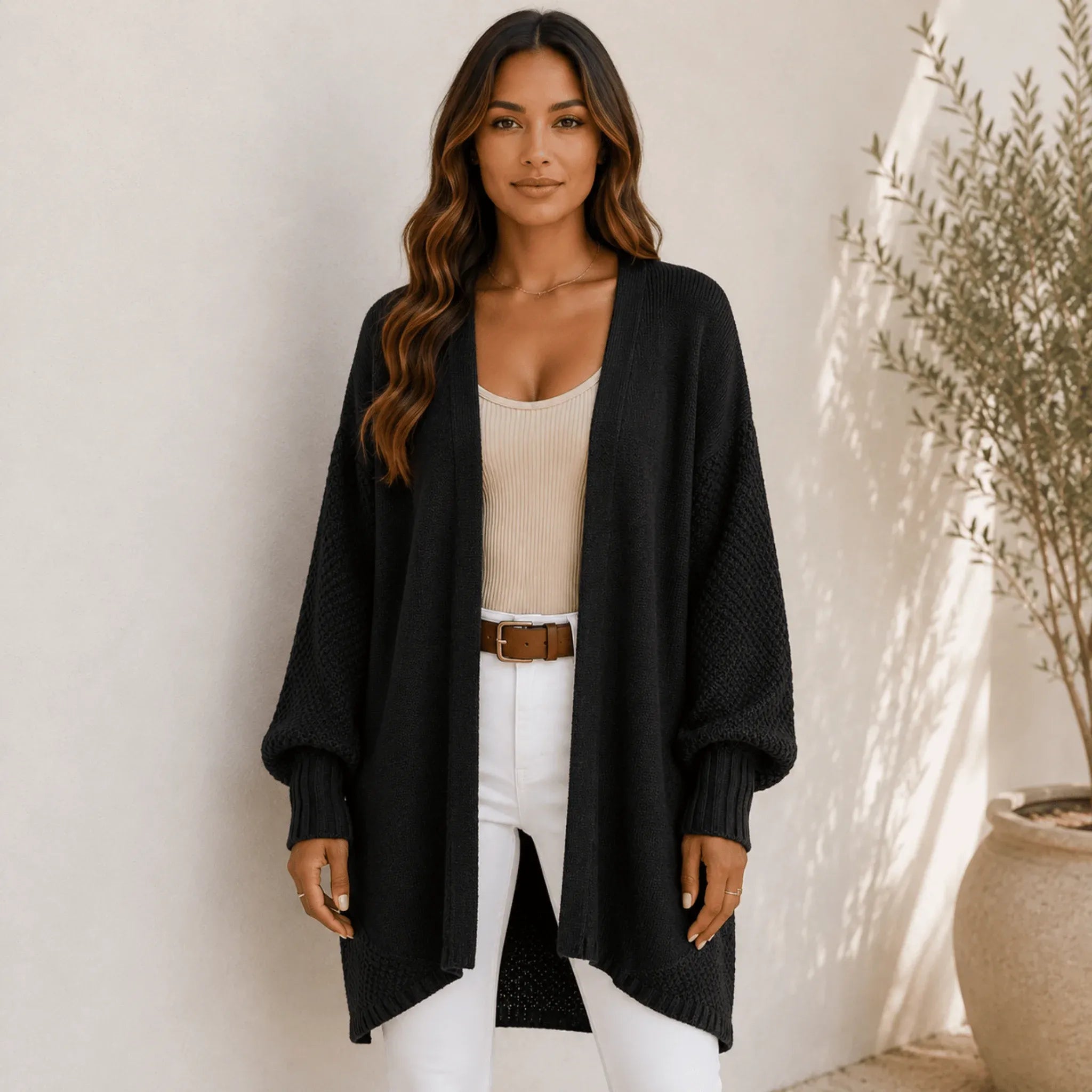 Women's black oversized open front long cardigan with textured knit sleeves, ribbed cuffs, and a cozy relaxed silhouette.