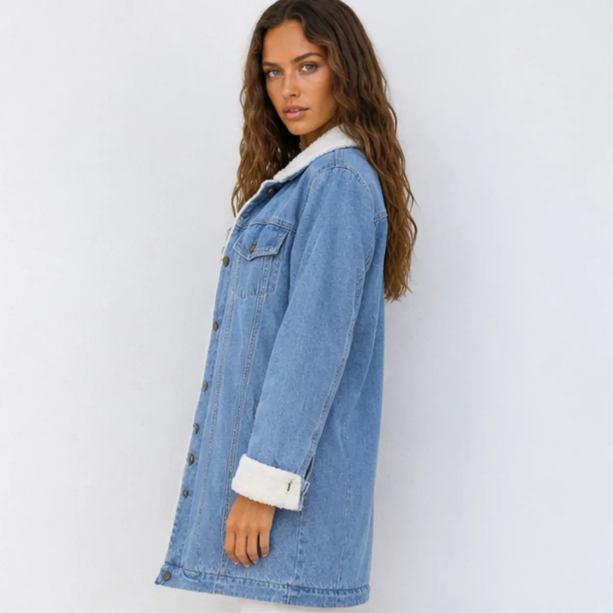 Side view of oversized blue sherpa-lined denim jacket with relaxed fit