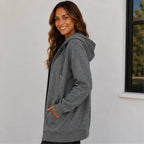 Women's oversized gray zip-up hooded jacket side view