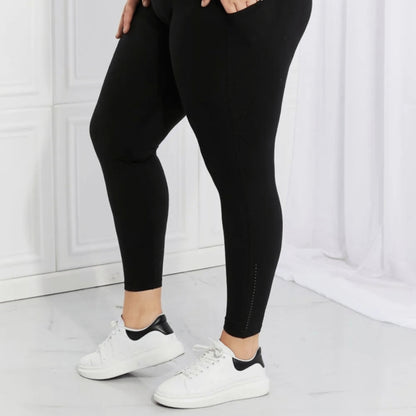 Final presentation of Leggings Depot reflective activewear against a soft curtain background.
