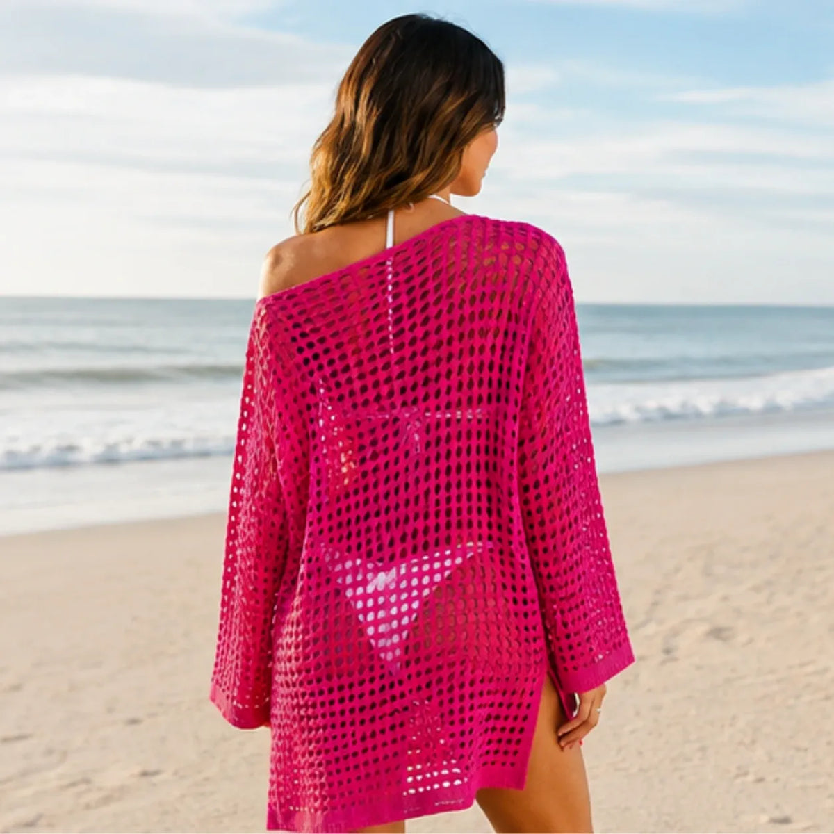 Back view of pink crochet beach cover-up at the beach