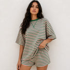 Woman wearing pink and dark green horizontal striped short-sleeve lounge shorts set