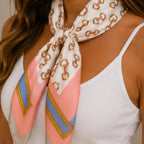 Close-up of a pink multi print bandana scarf featuring a nautical-inspired chain pattern and soft pink stripe accents.