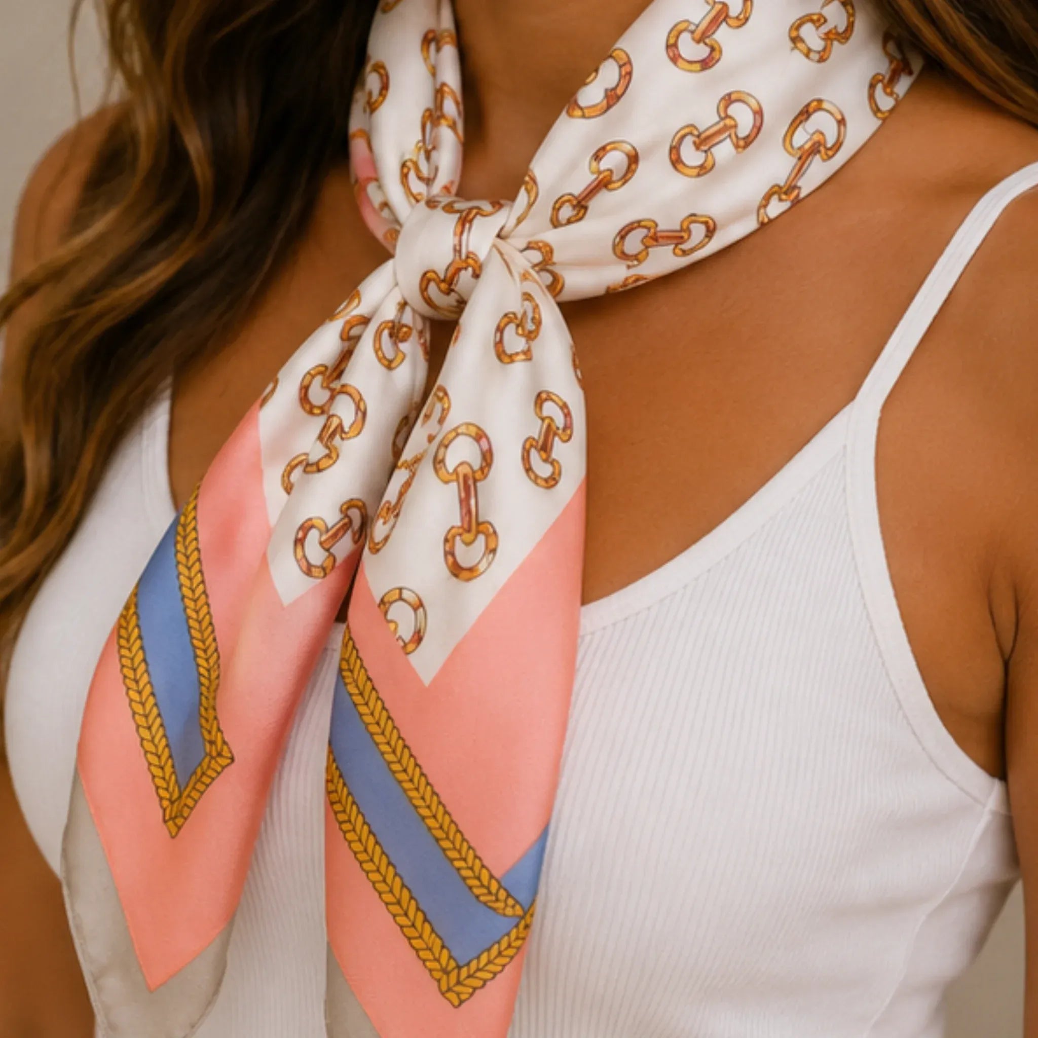 Close-up of a pink multi print bandana scarf featuring a nautical-inspired chain pattern and soft pink stripe accents.