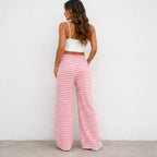 Back view of pink and white striped drawstring straight-leg pants