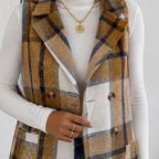 Close-up of camel plaid double-breasted long vest with button details and pockets