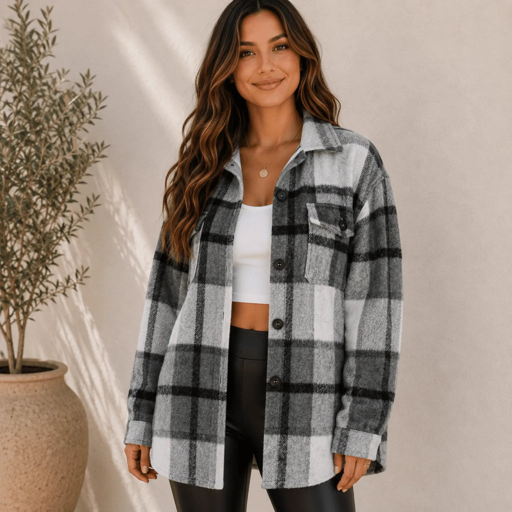 Women's grey plaid flannel button-up jacket with an oversized silhouette, button-front closure, long sleeves, and chest flap pockets.