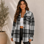 Women's grey plaid flannel button-up jacket with an oversized silhouette, button-front closure, long sleeves, and chest flap pockets.