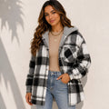 Woman wearing a black and white plaid sherpa-lined hooded shacket