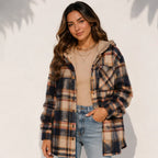 Front view of a woman wearing a brown plaid sherpa-lined hooded shacket
