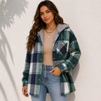 Woman wearing a green plaid sherpa-lined hooded shacket