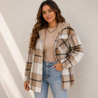 Woman wearing a khaki plaid sherpa-lined hooded shacket
