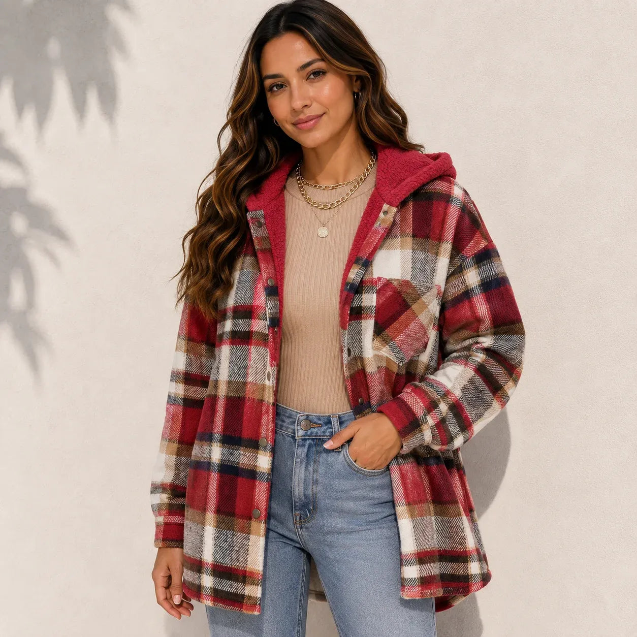 Woman wearing a red plaid sherpa-lined hooded shacket