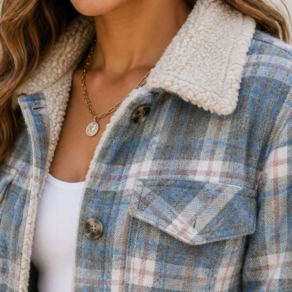 Close-up of the sherpa collar and plaid fabric on the sky blue stripe shirt jacket