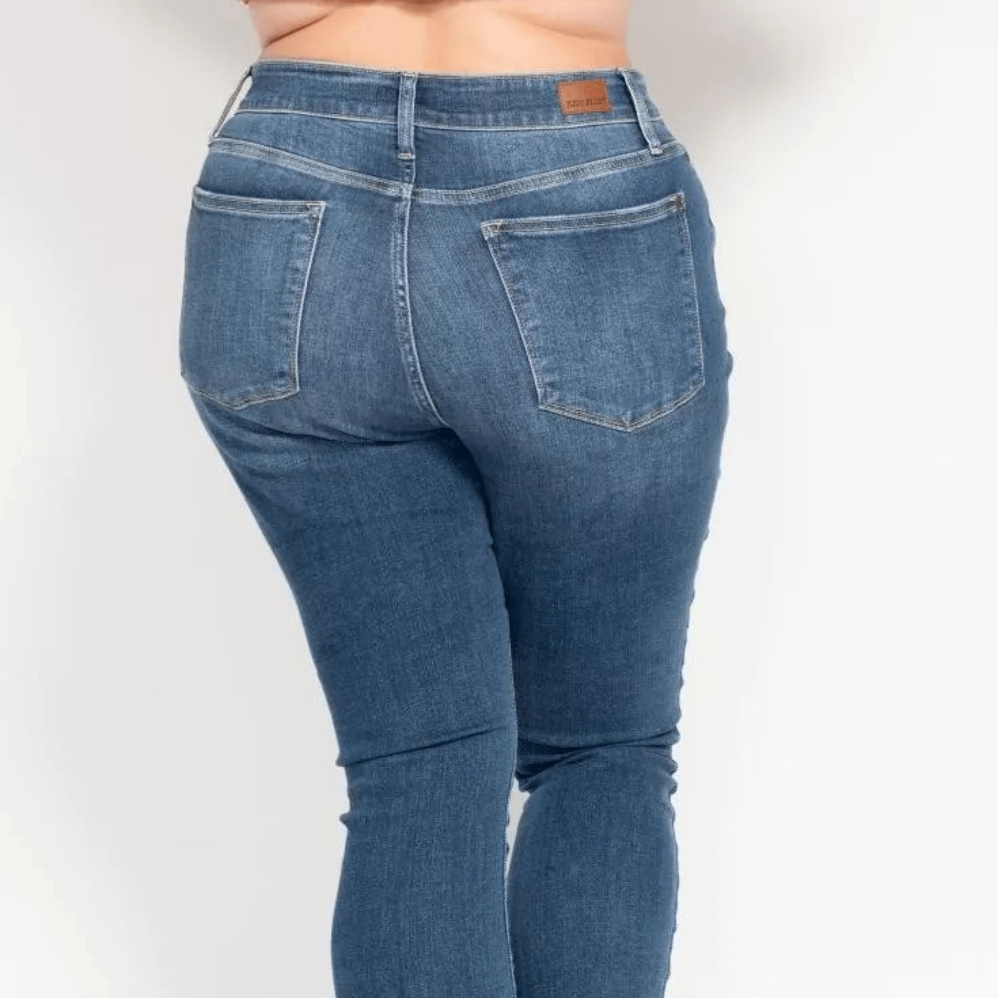 Detailed showcase of the medium wash denim and button fly.