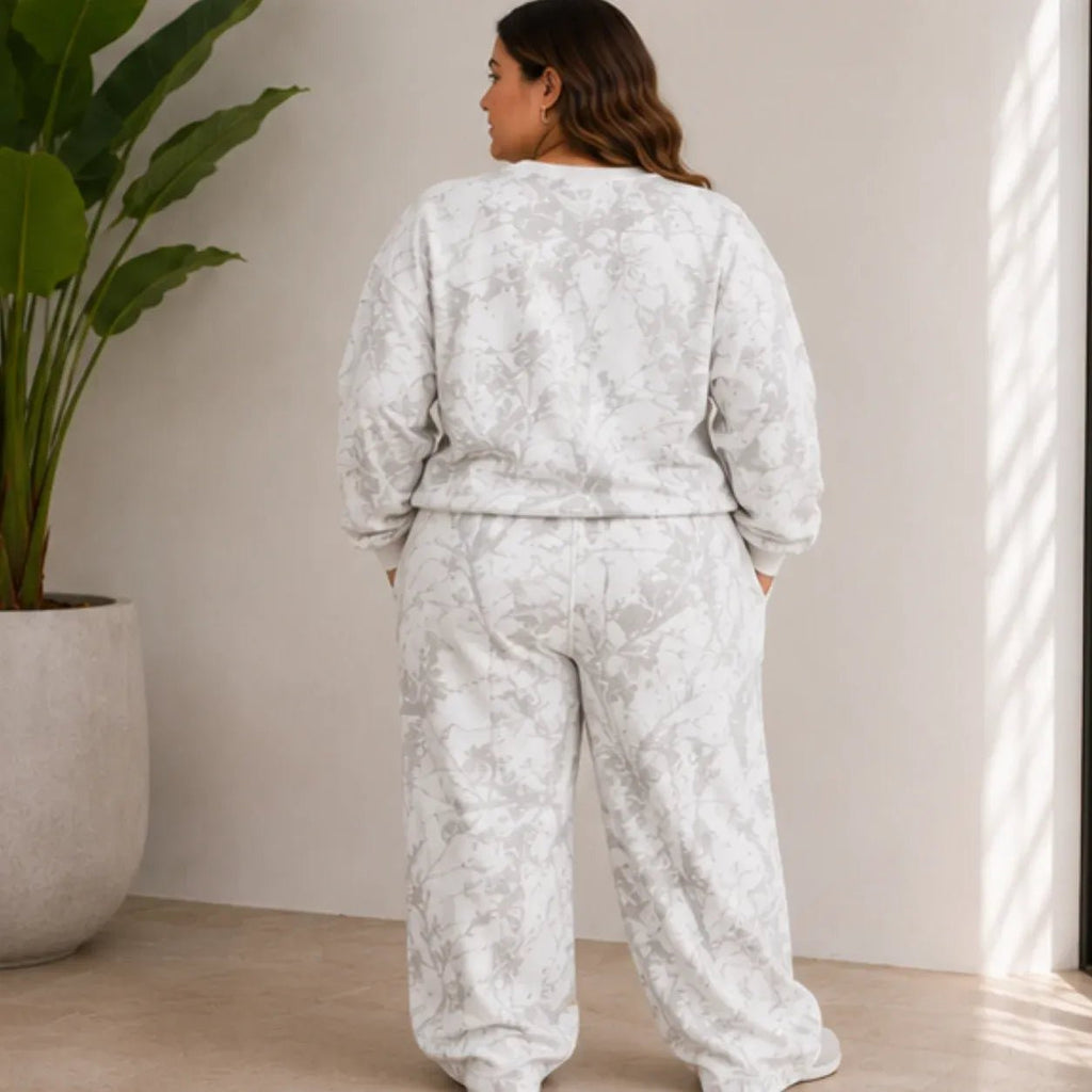 Plus size model wearing the camo maple leaf crewneck sweatshirt and sweatpants set shown from the back