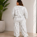 Plus size model wearing the camo maple leaf crewneck sweatshirt and sweatpants set shown from the back