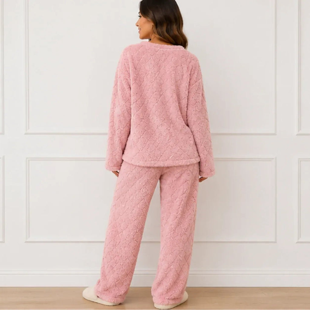 Back view of woman wearing a pink plush fleece pajama set with long sleeves and wide-leg pants