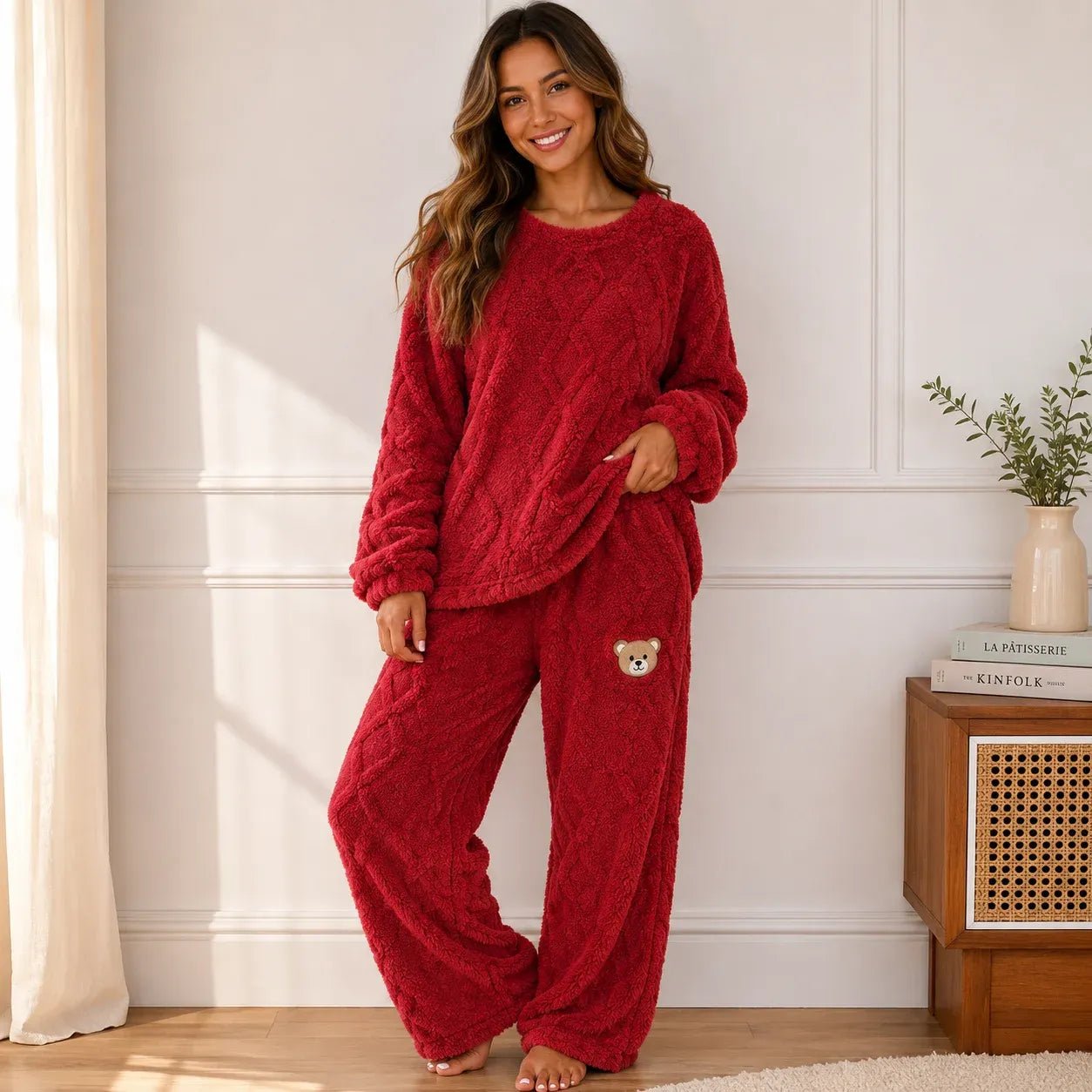 Woman wearing a cozy red plush fleece pajama set with long sleeves and wide-leg pants