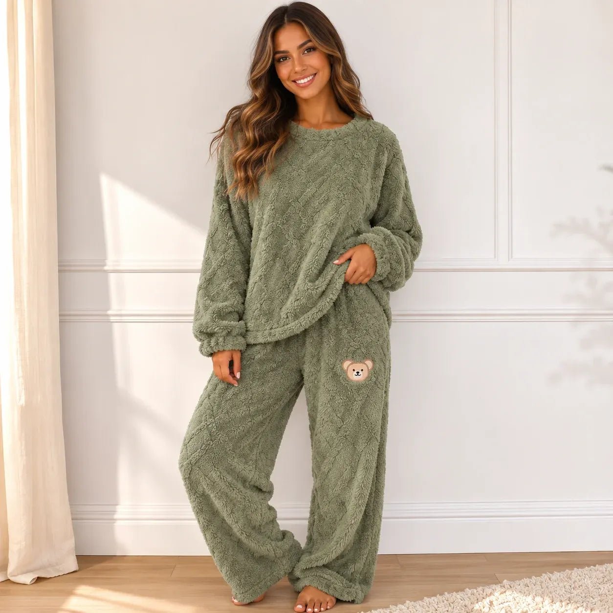 Woman wearing a cozy sage green plush fleece pajama set with long sleeves and wide-leg pants