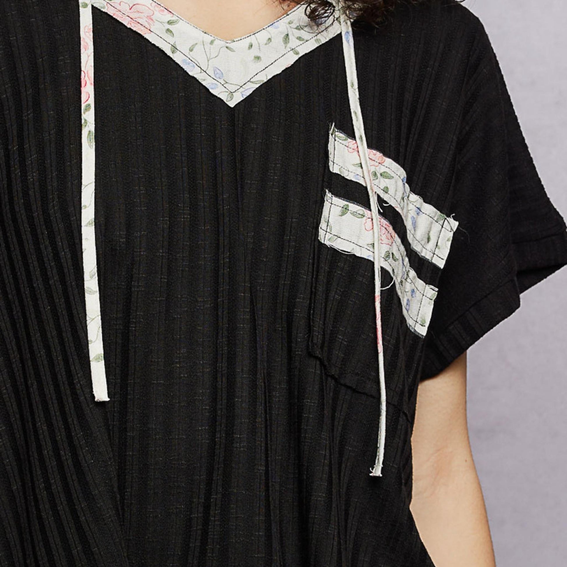 POL black short sleeve hooded top with hood and pocket — detail close-up.