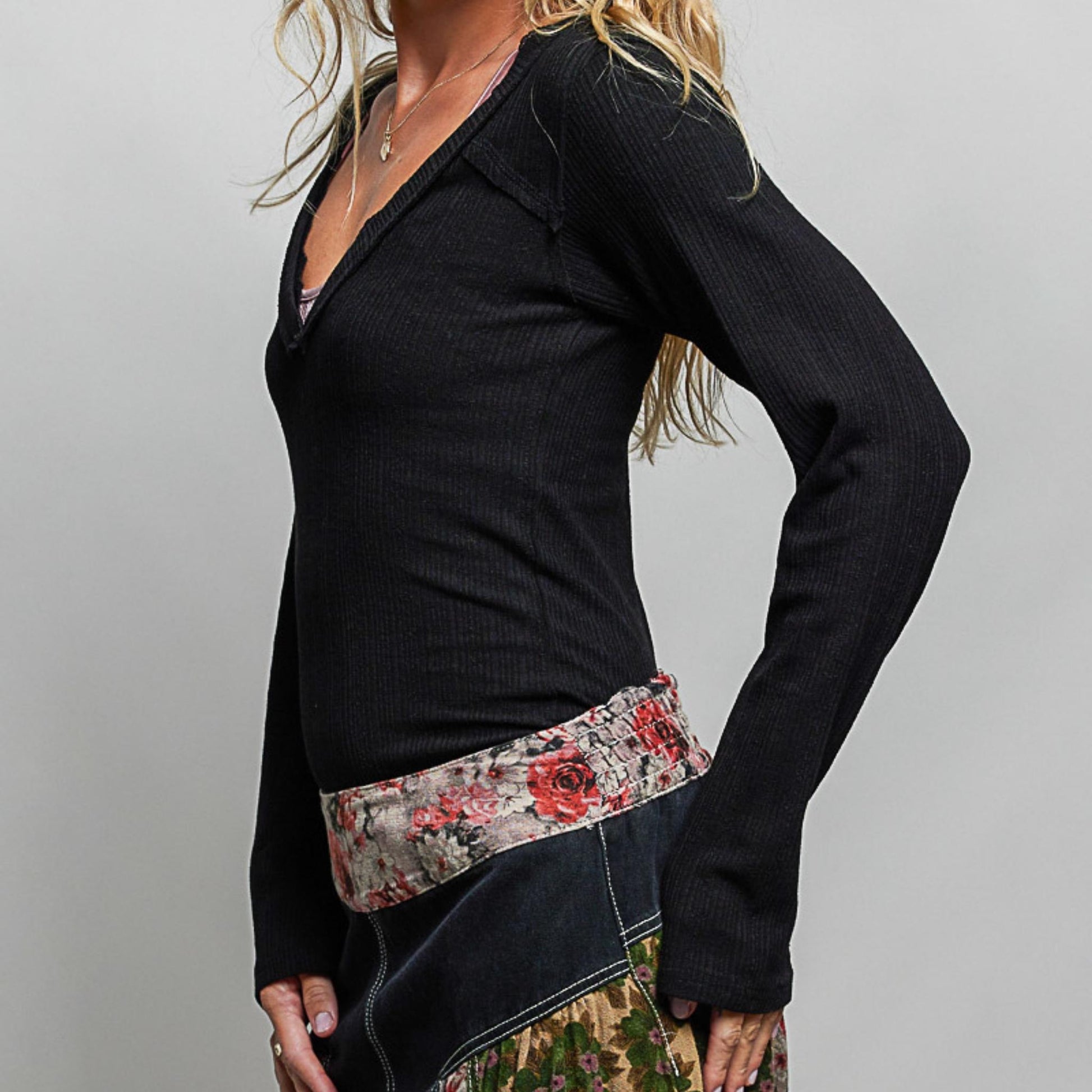 POL black v-neck long sleeve ribbed top showing slim fit — side perspective.